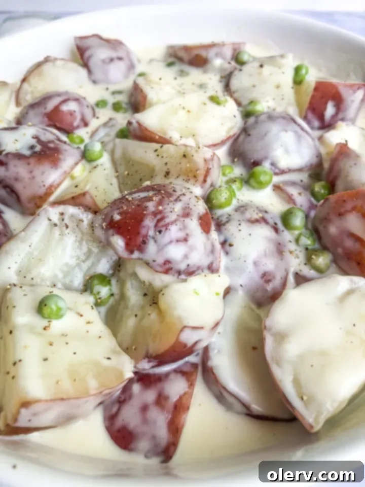 Velvet Red Potatoes and Sweet Peas 6 Close-up of Creamed Red Potatoes and Peas in a pan with cream sauce