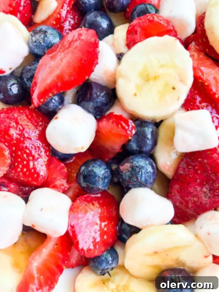 Bowl of Red White & Blueberry Fruit Salad with the honey lime glaze