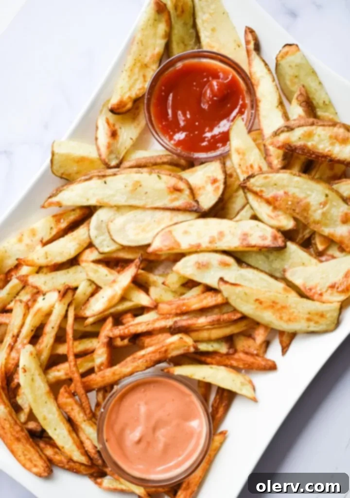 Mouthwatering Seasoned French Fries 3 Close-up of freshly cut potatoes, ready for preparation