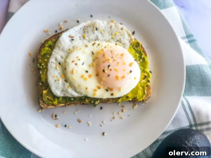 Savory Avocado Egg Toast 2 Perfectly prepared fried egg avocado toast, ready to be enjoyed.