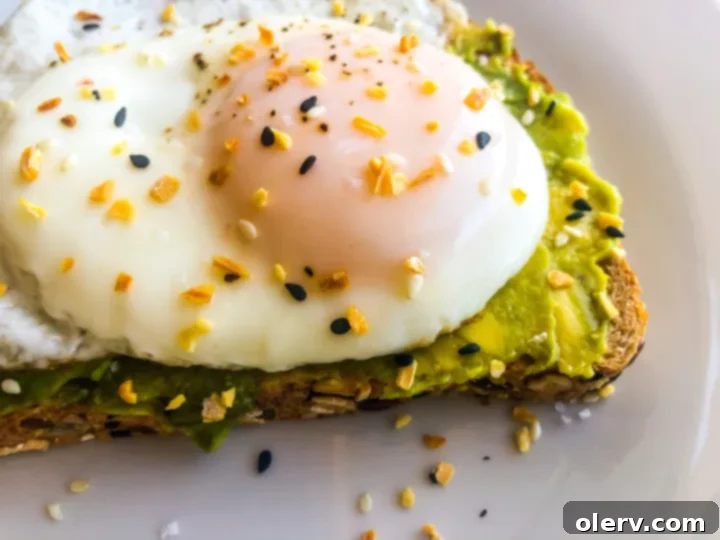 Savory Avocado Egg Toast 4 A perfectly fried egg with a runny yolk, ready to be placed on avocado toast.