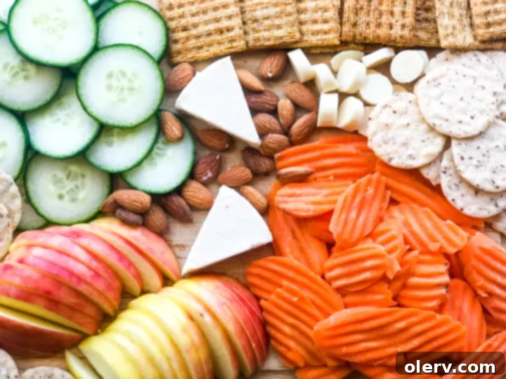 Effortless Summer Bites 5 A vibrant selection of fresh, seasonal fruits and vegetables, including berries, grapes, and sliced cucumbers, ready for a healthy snack.
