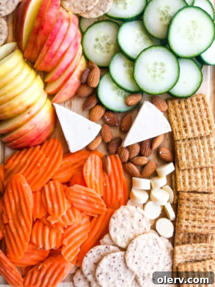 Effortless Summer Bites 8 Summer Snack Board with fresh fruits, vegetables, crackers, and cheese.