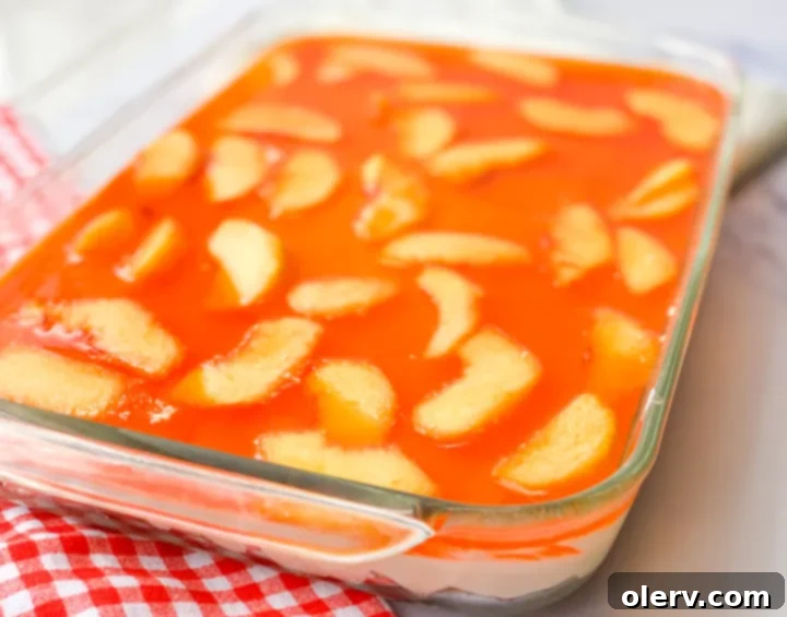 Beautiful slice of Peaches & Cream Pretzel Salad with distinct layers