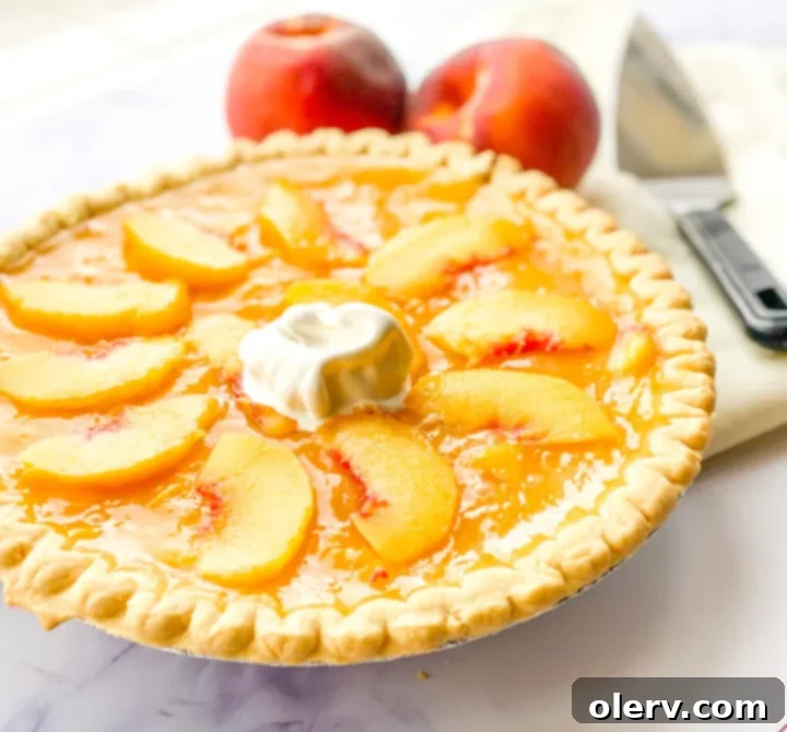 Golden Summer Peach Pie 3 A close-up of a rustic peach pie, showcasing the golden crust and peach filling