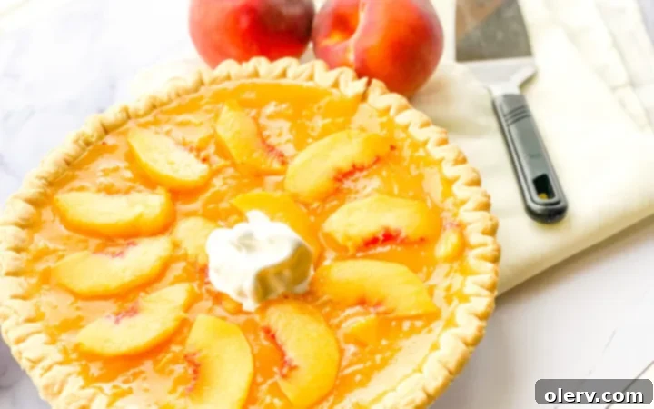 Golden Summer Peach Pie 6 A slice of chilled fresh peach pie with whipped cream