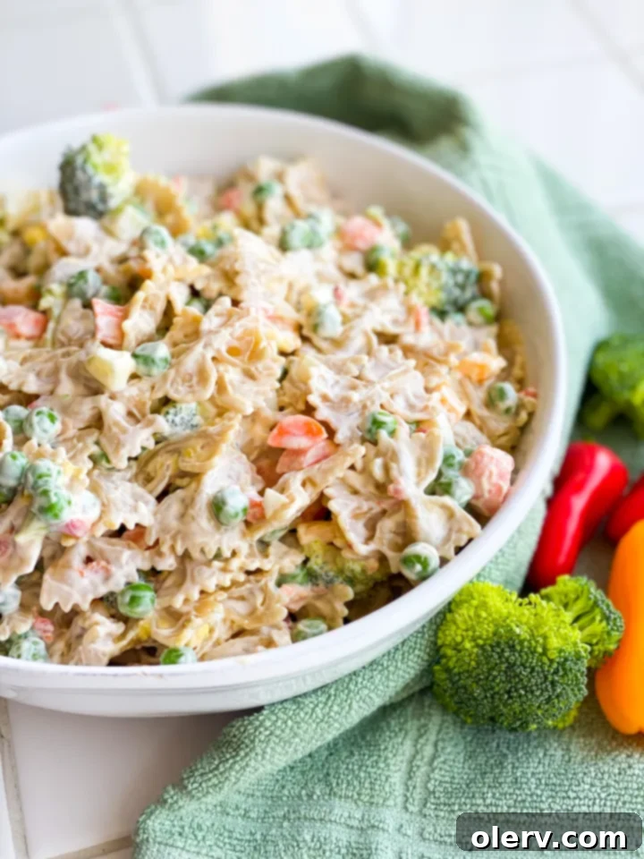 Velvety Farfalle Pasta Salad 3 Overhead shot of Creamy Bow Tie Pasta Salad in a clear bowl, highlighting the creamy texture and diverse ingredients.