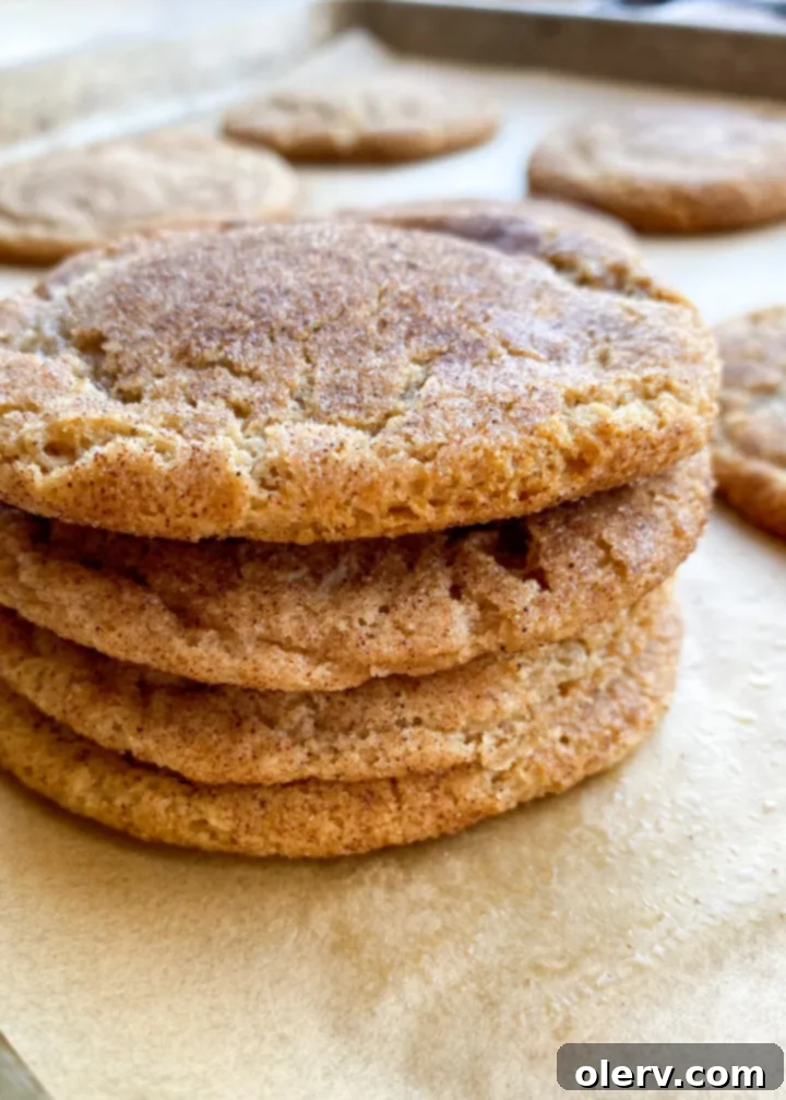 Comforting Maple Snickerdoodles 6 A bowl of maple syrup next to a plate of Maple Snickerdoodle cookies, highlighting the key ingredient.