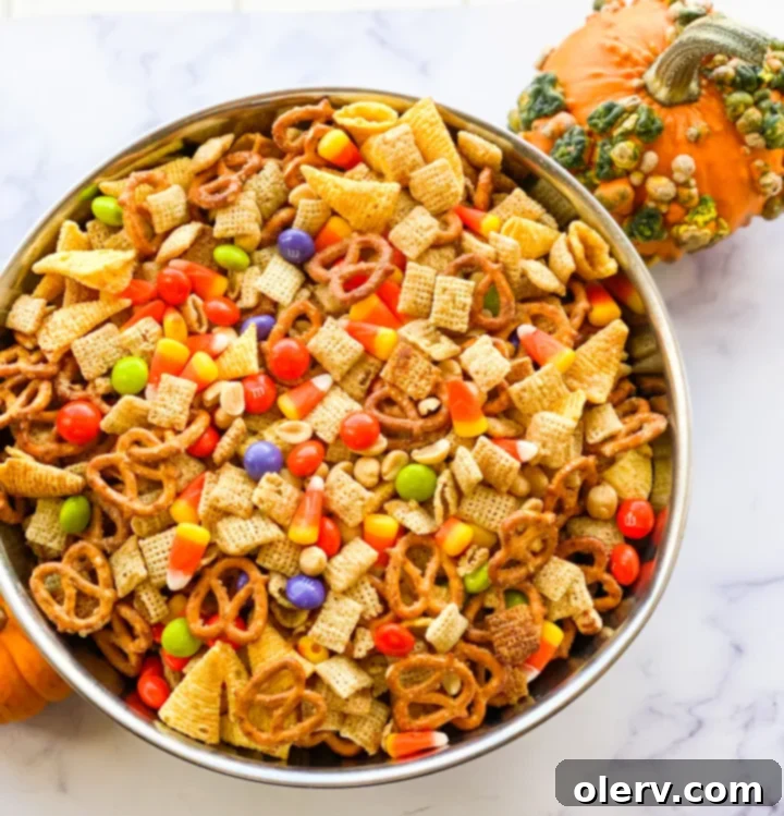 Monster Munch 2 Delicious Halloween Chex Mix piled high with candy corn and peanut butter M&Ms