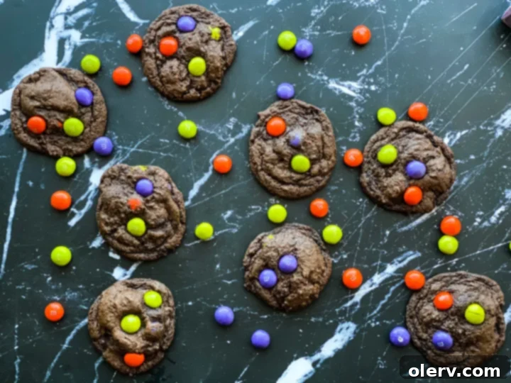 Spooktacular M&M Chocolate Cookies 2 Delicious Halloween M&M chocolate cookies with festive purple, green, and orange candies
