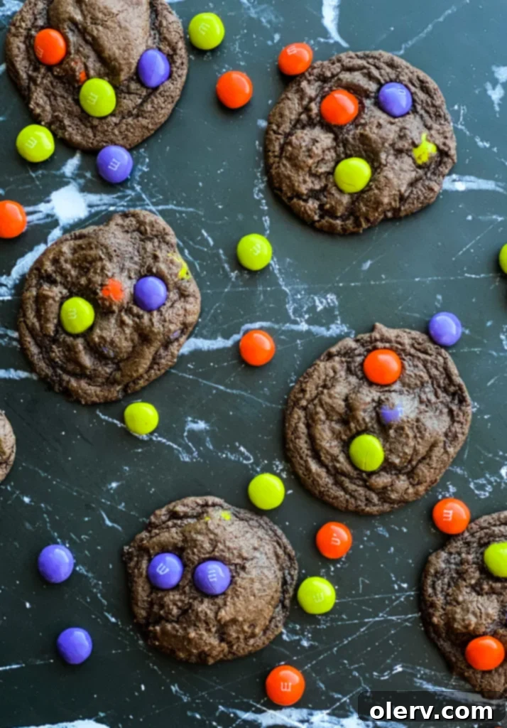 Spooktacular M&M Chocolate Cookies 3 Close-up of a stack of freshly baked Halloween M&M cookies, showcasing their soft texture