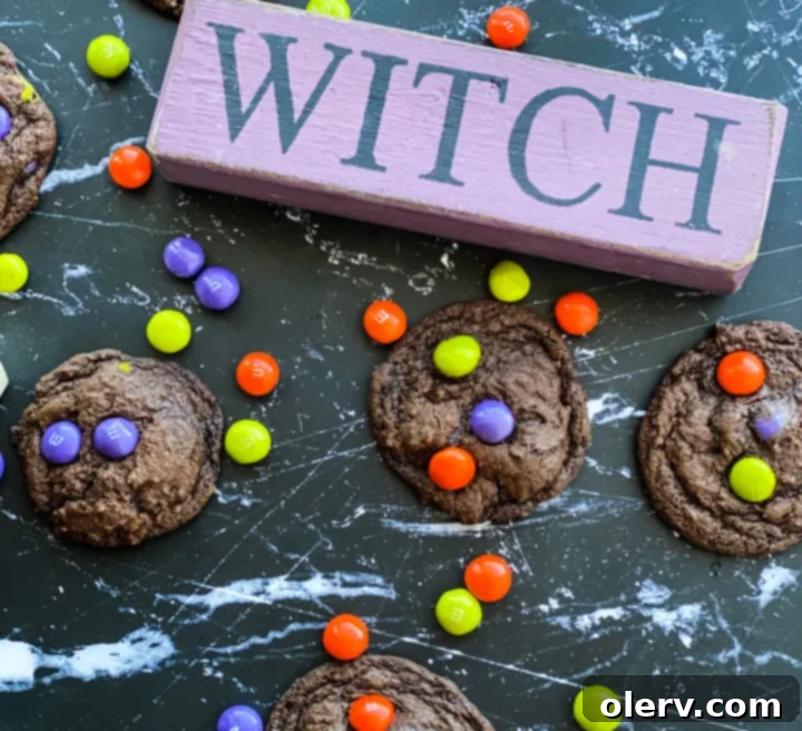 Spooktacular M&M Chocolate Cookies 4 A chocolate M&M cookie broken in half, revealing its soft interior and colorful candies