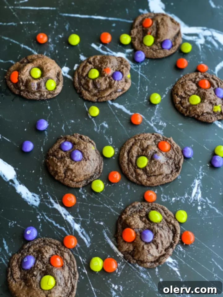 Spooktacular M&M Chocolate Cookies 5 A single Halloween M&M chocolate cookie on a cooling rack, perfectly baked