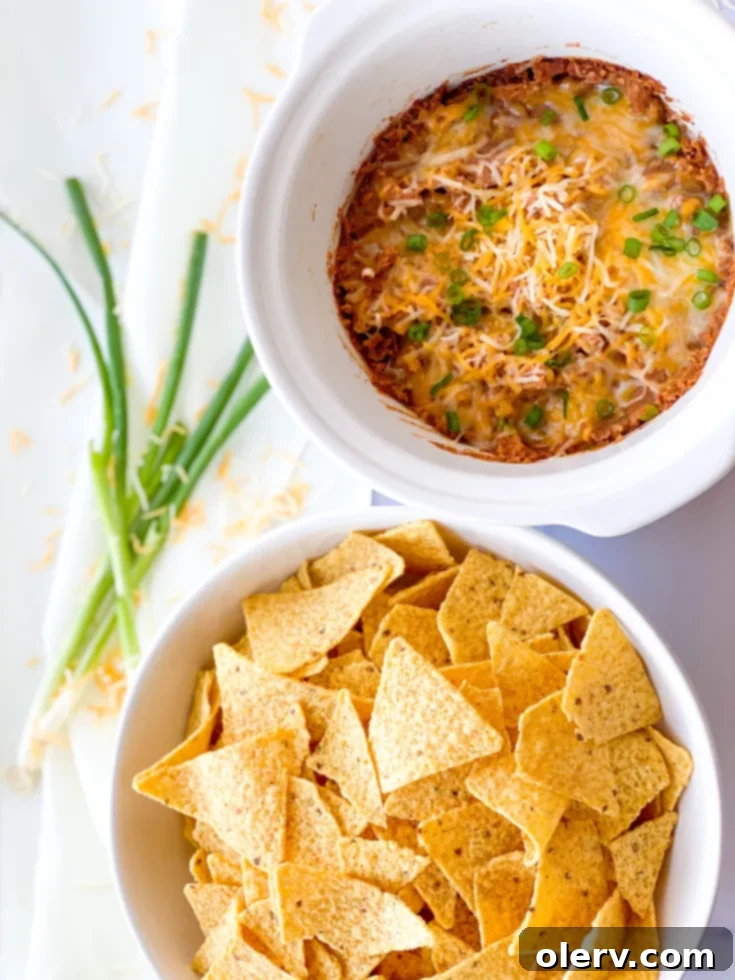 Effortless Slow Cooker Bean Dip 7 The finished Slow Cooker Bean Dip, hot and cheesy, ready to be served from the crock pot.