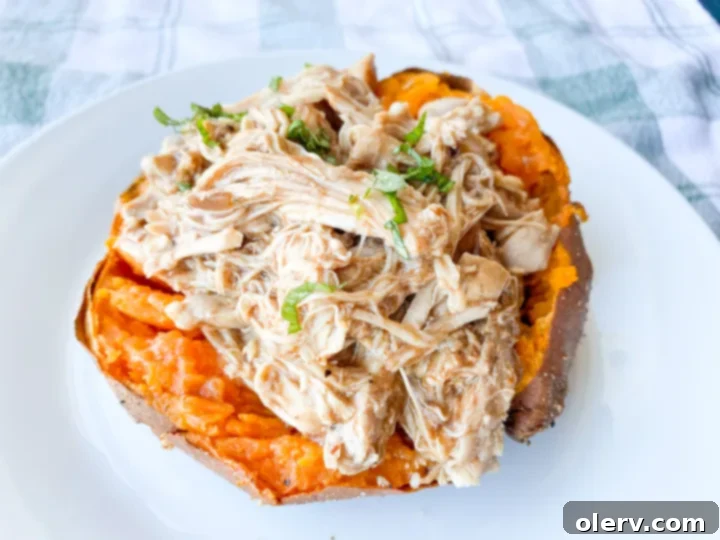 Four air-fried sweet potatoes with crispy skins, sitting on an air fryer rack, ready to be split and stuffed.