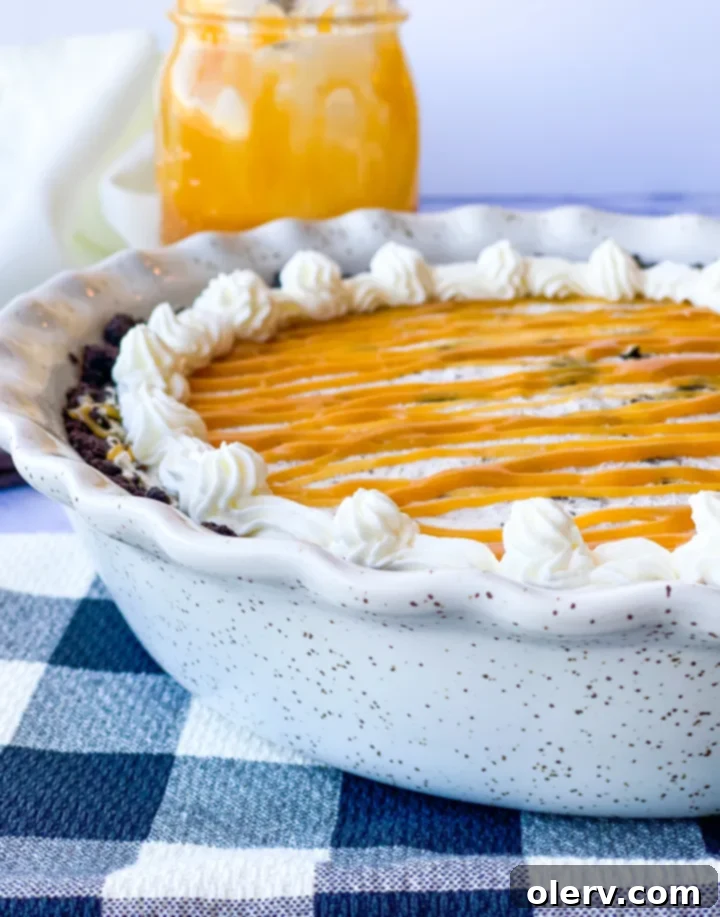 Decadent Salted Caramel Oreo Pie 5 The creamy cookies and cream filling being spread into the Oreo pie crust.