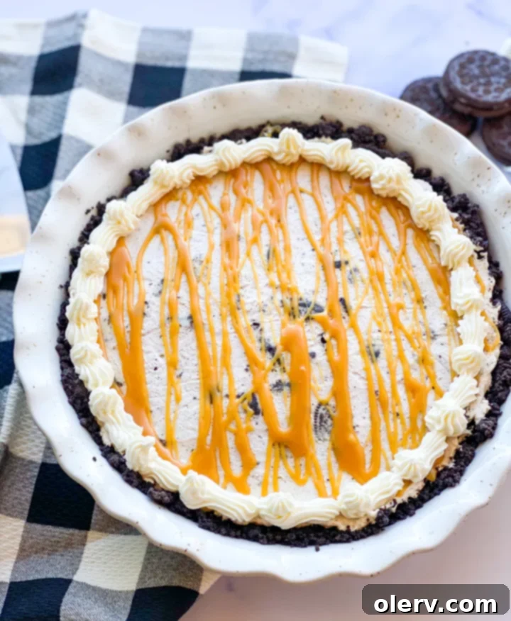 Decadent Salted Caramel Oreo Pie 6 A beautifully sliced Salted Caramel Oreo Pie, garnished with whipped cream and more caramel drizzle.
