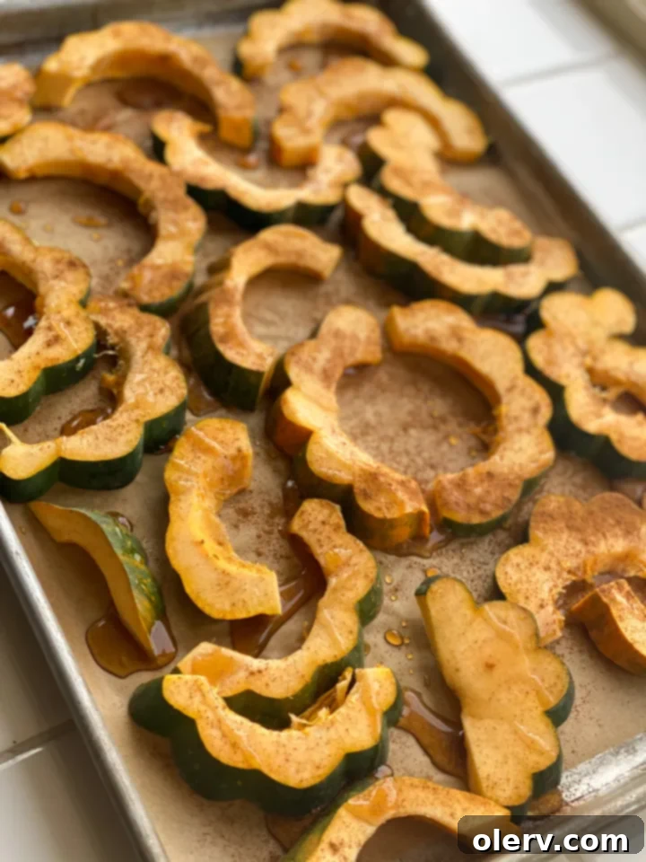Caramelized Roasted Acorn Squash 4 Acorn squash slices arranged on a baking sheet, ready for the maple butter glaze