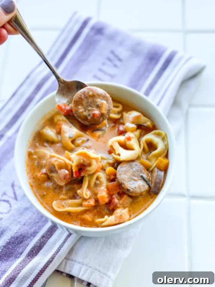 Hearty Sausage and Tortellini Soup 7 A full pot of creamy sausage and tortellini soup simmering on the stove.