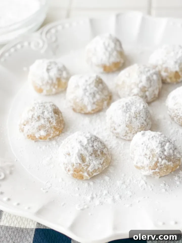 Fiesta Snowball Delights 6 A pile of Mexican Wedding Cookies on a wire rack
