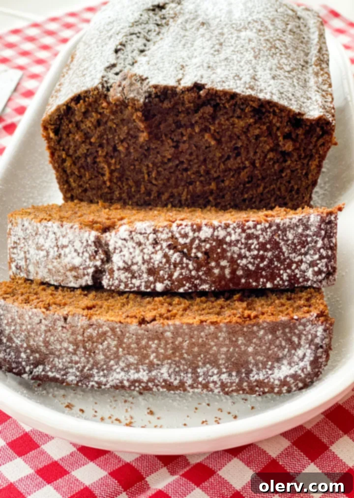 Warm Spiced Gingerbread Loaf 6 A perfectly baked gingerbread loaf, sliced and arranged on a serving plate, inviting guests to enjoy its festive flavors.