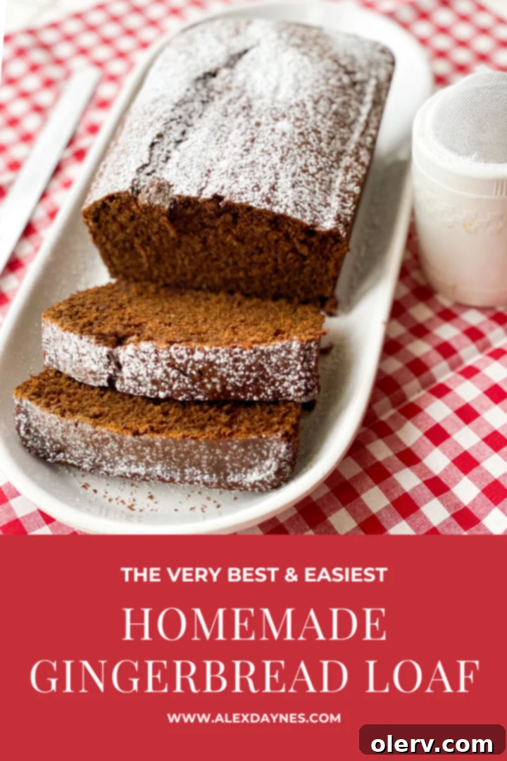 Homemade Gingerbread Loaf with powdered sugar, ready to be pinned.