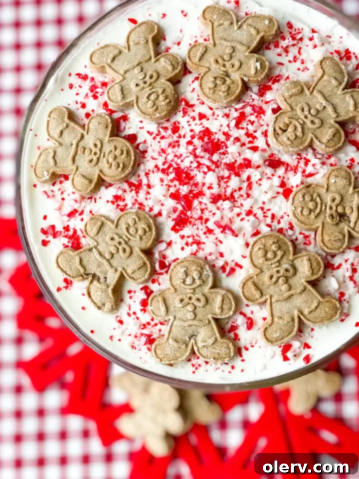 Yuletide Layers of Bliss 4 A close-up shot of the top layers of the Christmas Trifle, garnished with crushed gingerbread cookies and peppermint candy canes.