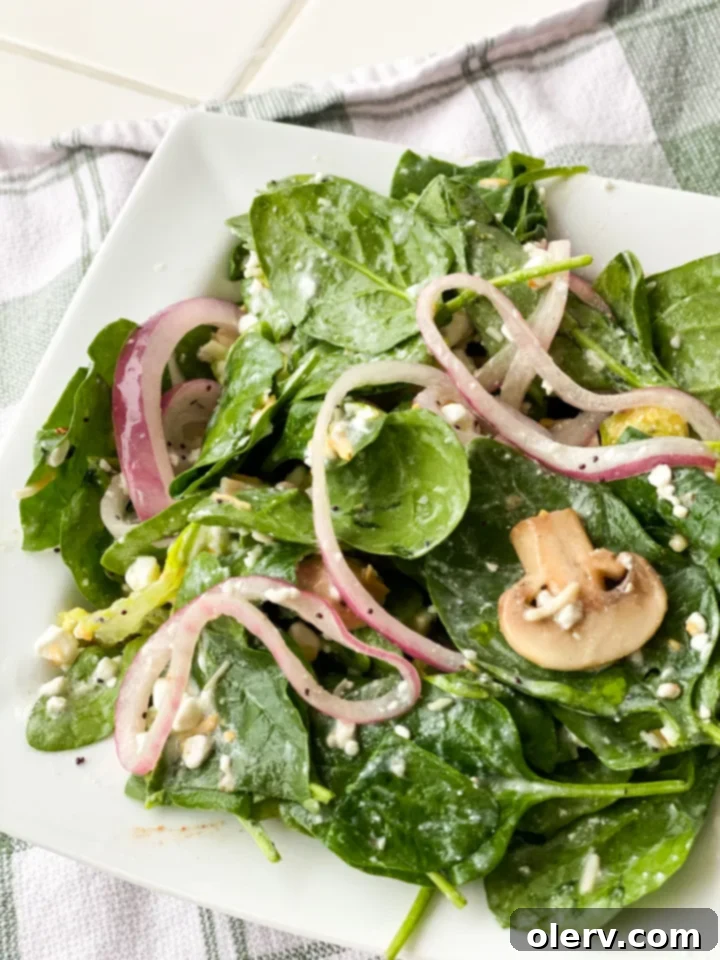 Effortless Marinated Spinach Delight 3 Close-up of the flavorful marinated mushrooms and red onions that form the salad's dressing.