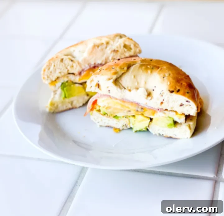 Ham, Egg, and Cheese Bagel Sandwich 2 A delicious ham, egg, and cheese bagel sandwich with fresh avocado slices.