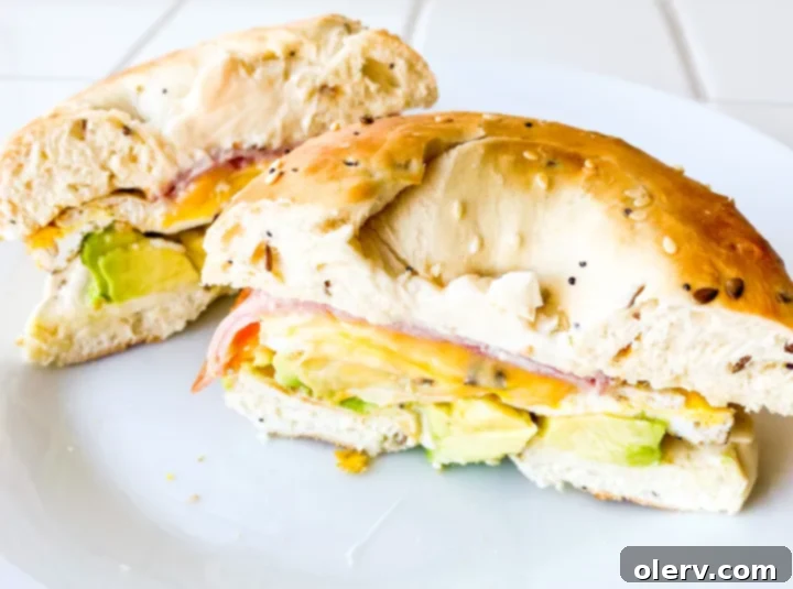 Ham, Egg, and Cheese Bagel Sandwich 6 Prepared ham, egg, and cheese bagel sandwich with avocado, ready to eat.