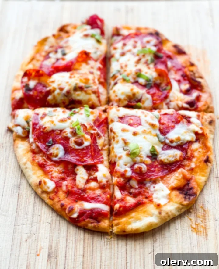 Crispy Air Fryer Pizza 7 A freshly cooked air fryer pizza with perfectly melted cheese and crispy pepperoni, topped with fresh basil.