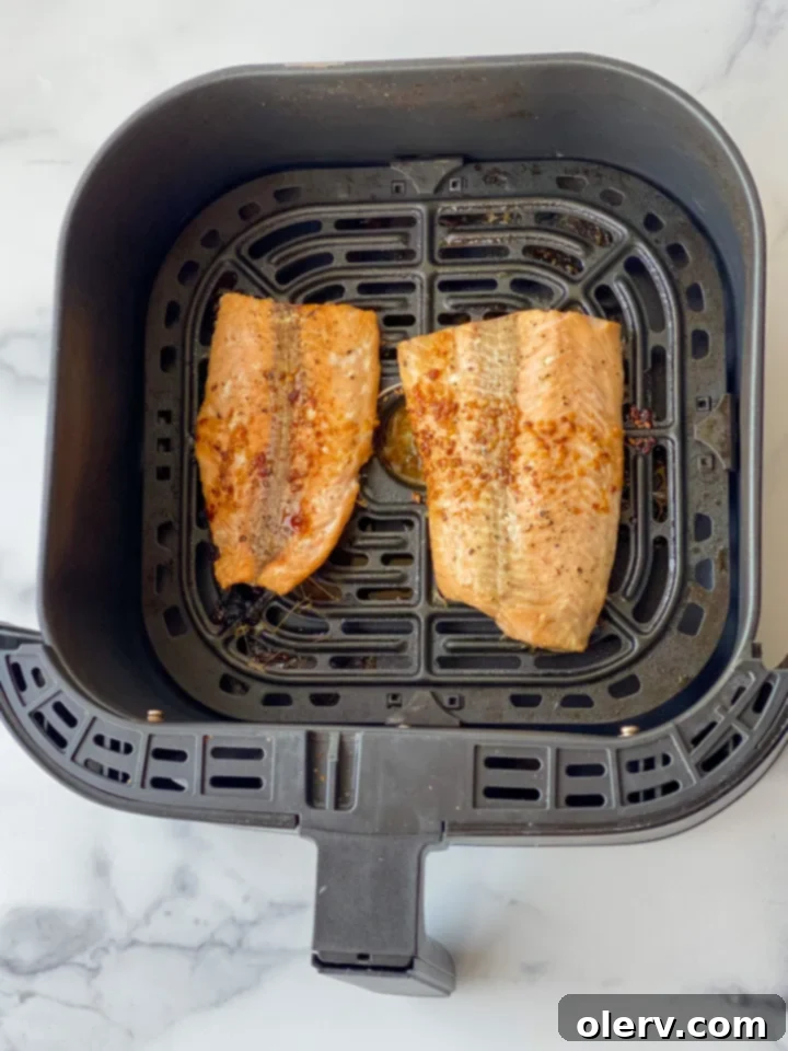 Easy Air Fryer Salmon and Veggies 5 Vibrant green broccoli florets seasoned with olive oil, salt, and pepper