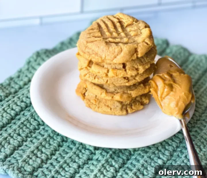 Effortless Three Ingredient Peanut Butter Cookies 3 A bowl of creamy peanut butter, granulated sugar, and an egg, the three simple ingredients for this cookie recipe.