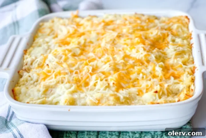 Irresistible Cheesy Potato Gratin 3 Close-up of the creamy, cheesy potato mixture before baking, showing shredded potatoes and rich sauce.