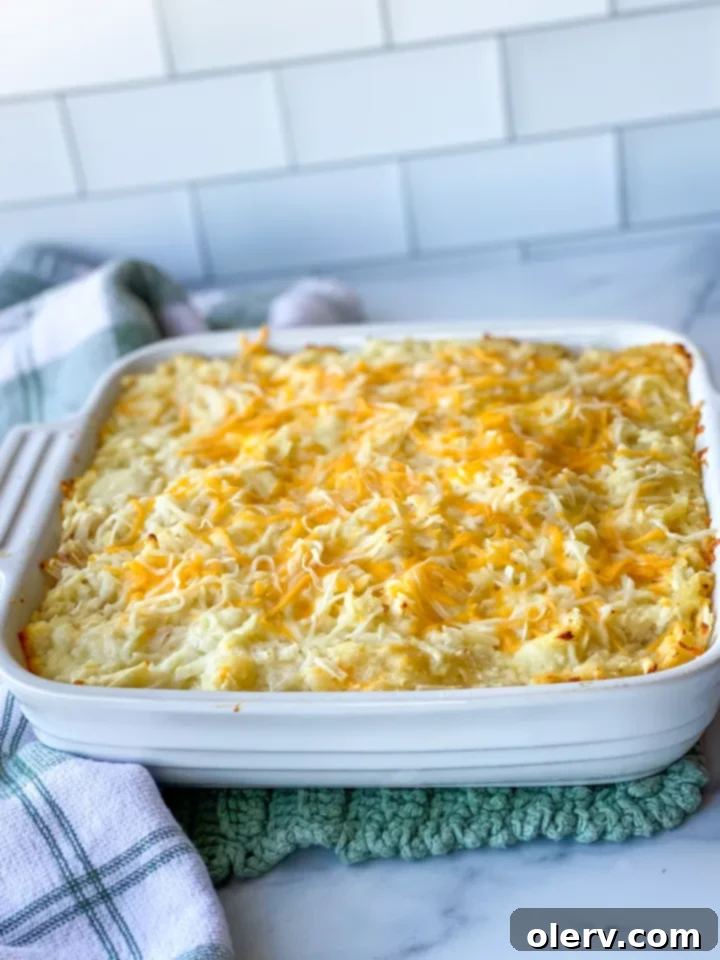 Irresistible Cheesy Potato Gratin 4 A large baking dish filled with the cheesy potato casserole, ready to be baked to golden perfection.