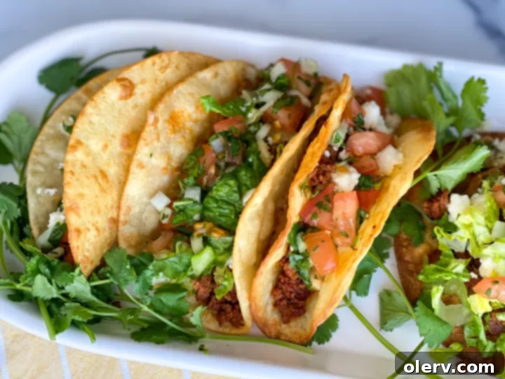 Various taco toppings laid out, including seasoned meat, fresh pico de gallo, and cheese.