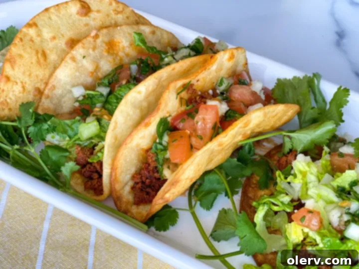 Freshly fried crispy taco shells draining on paper towels, ready for salt.