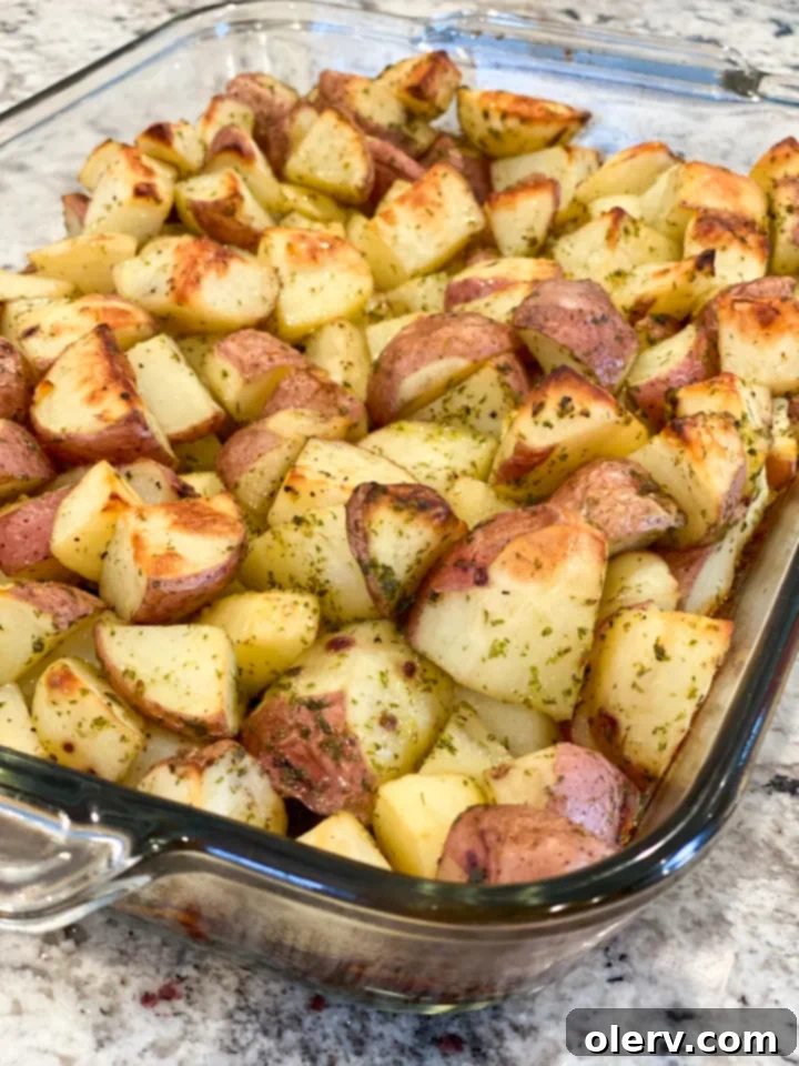 Crispy Garlic Roasted Potatoes 4 Close-up of golden crispy garlic roasted potatoes in a baking dish.