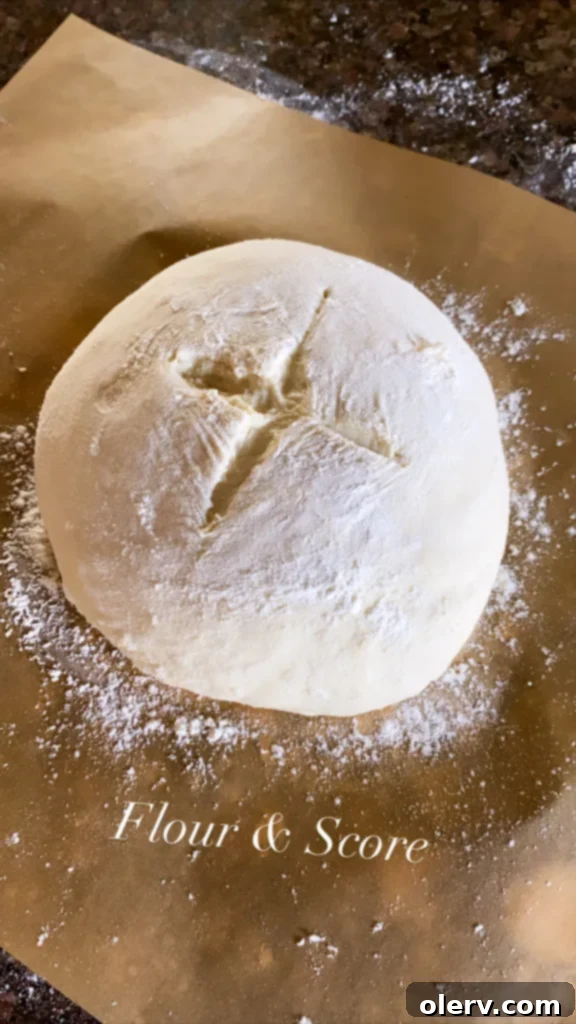 Baking Bread Made Simple 6 Hand stirring bread dough in a glass bowl with a wooden spoon