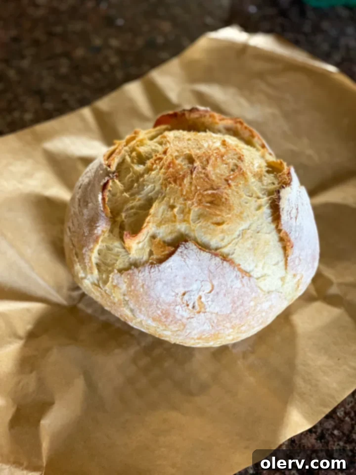 Baking Bread Made Simple 8 Freshly baked easy homemade bread being sliced on a wooden board