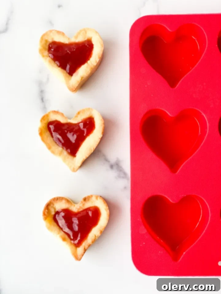 Sweet Strawberry Tartlets 4 Empty heart-shaped molds waiting for the tart dough, highlighting their charming design and inviting creativity.