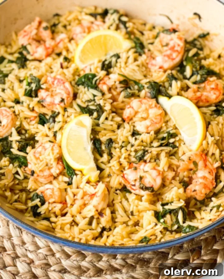A hand squeezing fresh lemon juice over ingredients for Lemon Shrimp Scampi, highlighting the importance of using real, natural lemons.