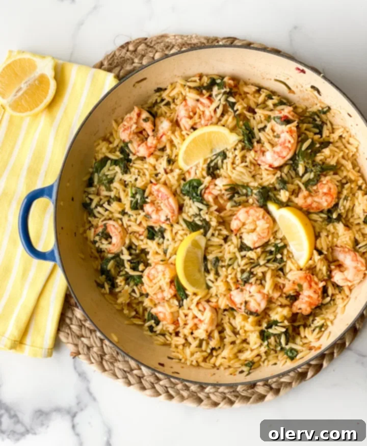 Hero image of the finished Lemon Shrimp Scampi dish on a plate with fresh lemon wedges, ready to be enjoyed.