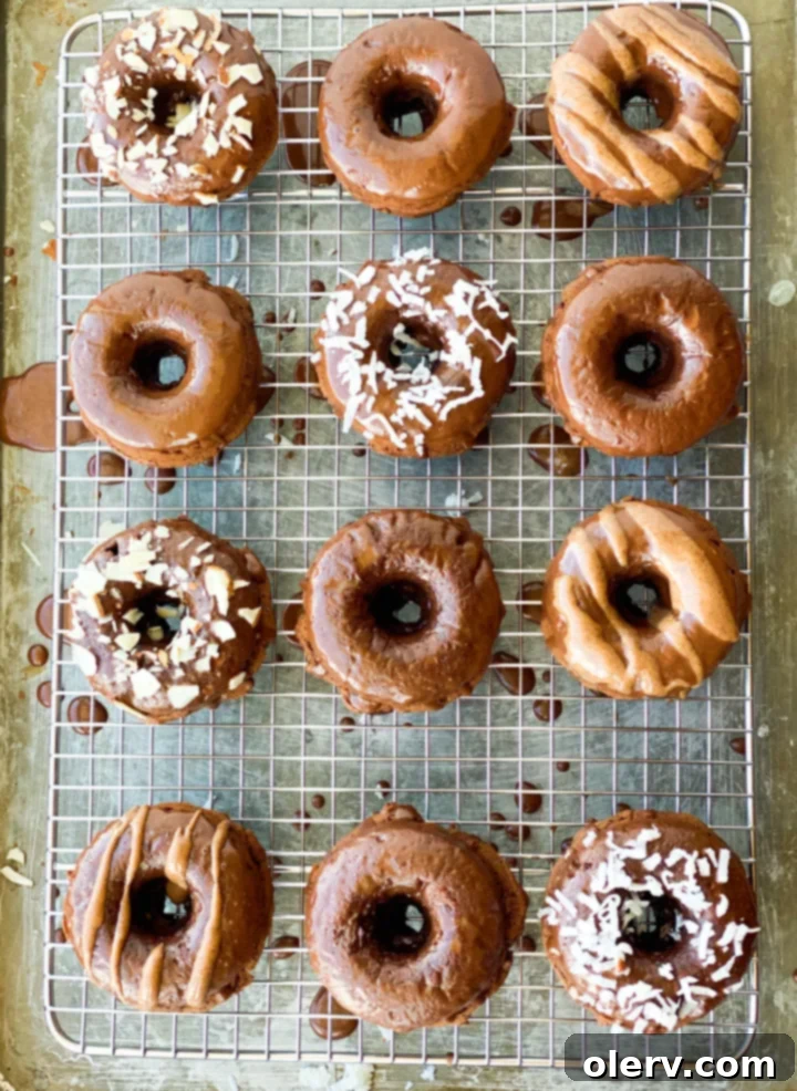 Almond Coconut Donuts: A Midnight Delight 4 A stack of three Midnight Almond Coconut Donuts on a white plate, showcasing their inviting glaze and texture.
