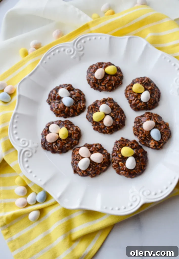 Easy No-Bake Easter Nests 2 Delicious No-Bake Easter Nest Cookies topped with colorful mini Cadbury eggs, perfect for spring.