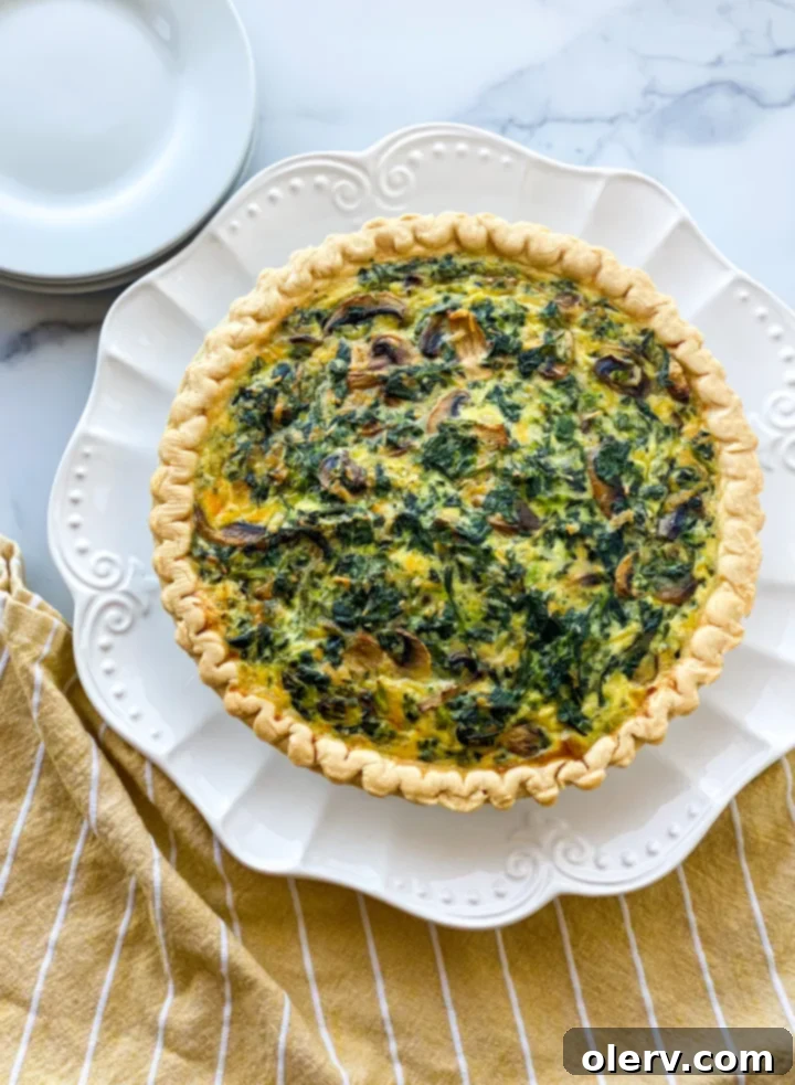 Savory Spinach and Creamy Cheese Quiche 7 A perfect slice of Spinach and Cheese Quiche on a white plate