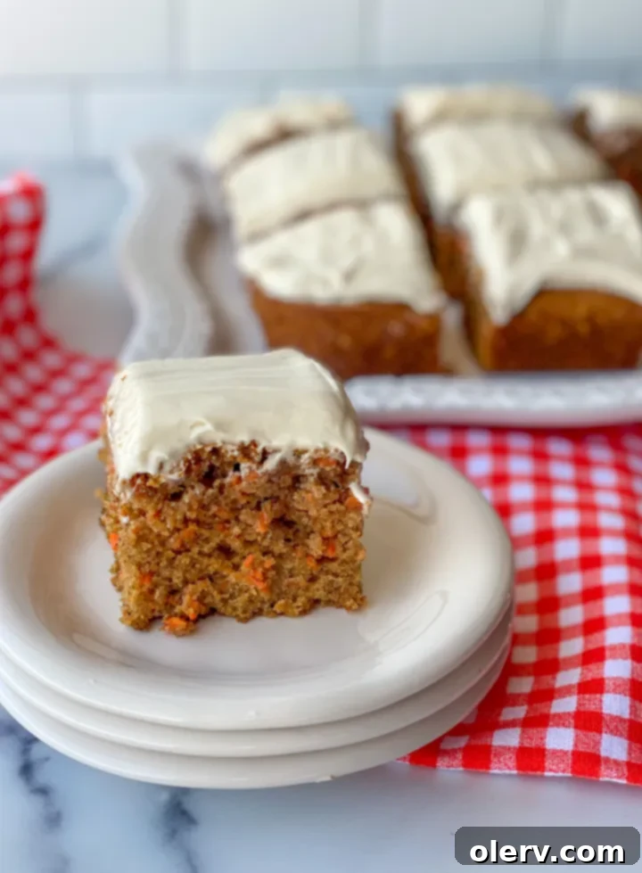 No-Fuss Carrot Cake Bars 2 Deliciously moist carrot cake bars topped with rich cream cheese frosting, ready to be enjoyed.