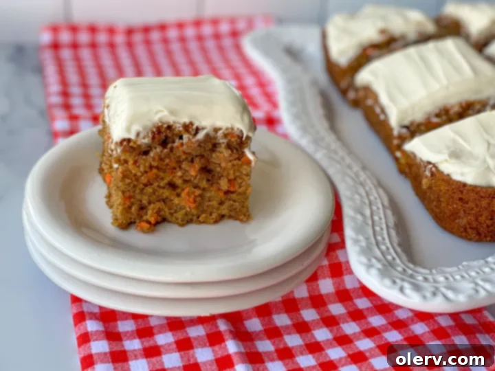 No-Fuss Carrot Cake Bars 3 A baking dish filled with freshly prepared carrot cake bars, cooling before frosting.