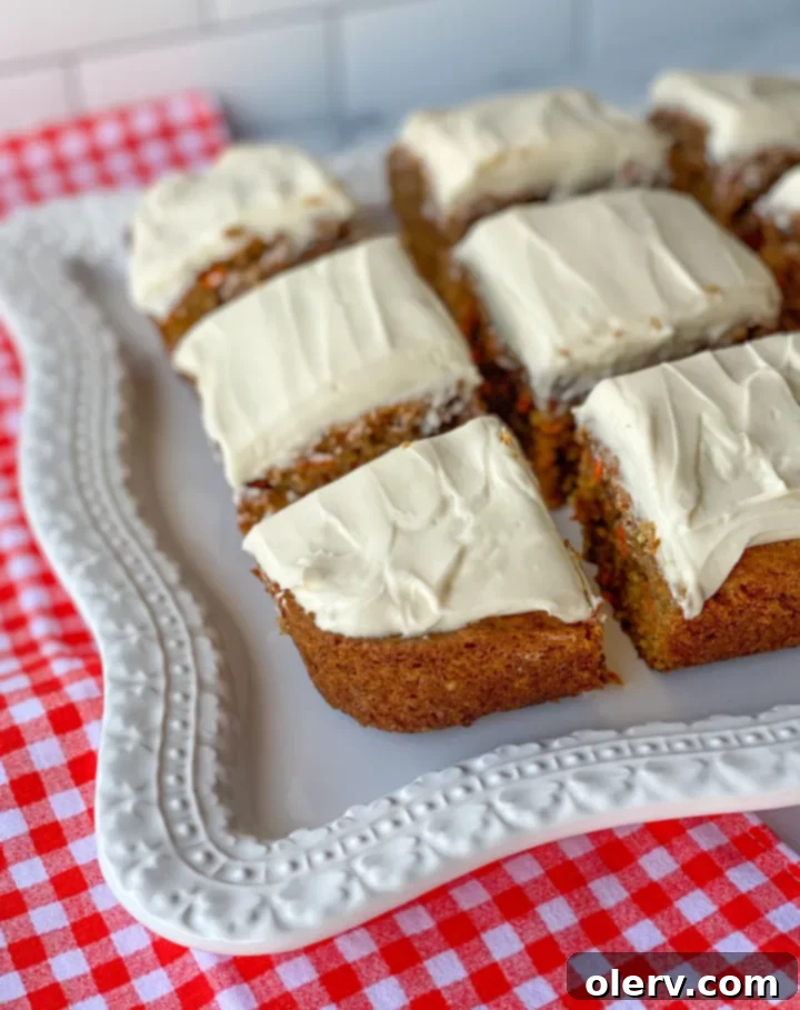 No-Fuss Carrot Cake Bars 5 A close-up shot of frosted carrot cake bars, showcasing their moist texture and creamy topping.
