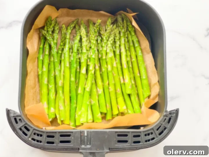 Perfectly Crispy Air Fryer Asparagus 2 Freshly cooked crispy air fryer asparagus spears in a serving dish, ready to eat.